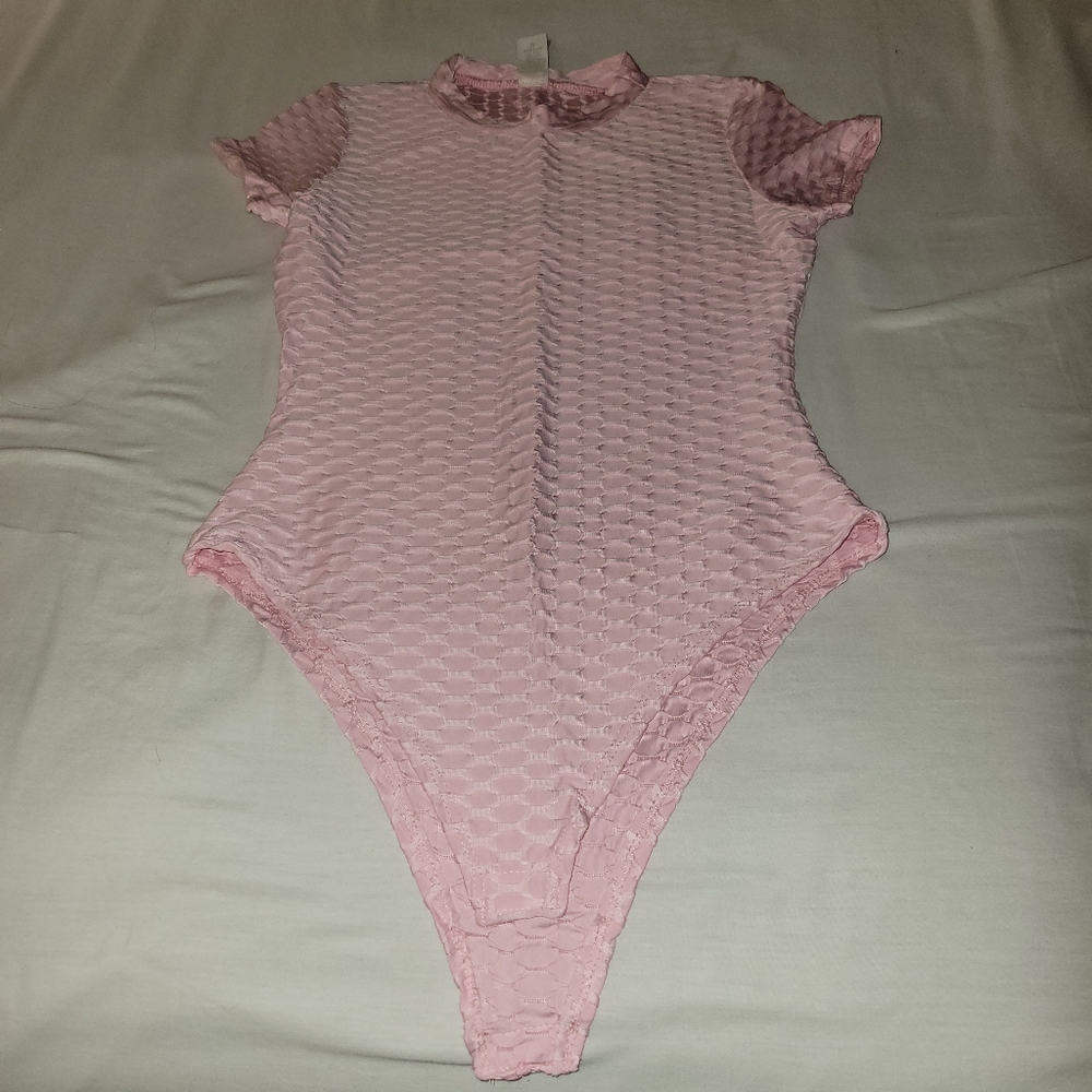 Baby pink textured bodysuit with snap closure. New without tags